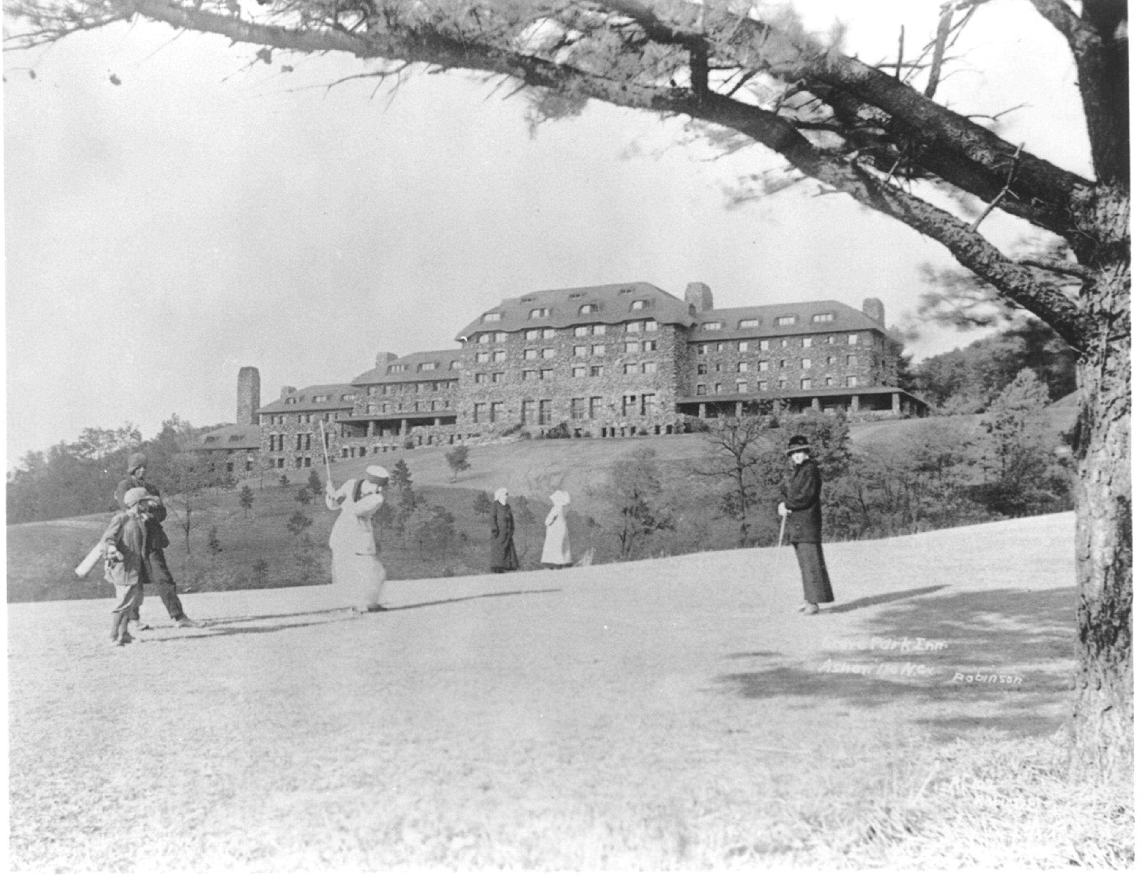 A historical black-and-white image of the Grove Park Inn in Asheville
