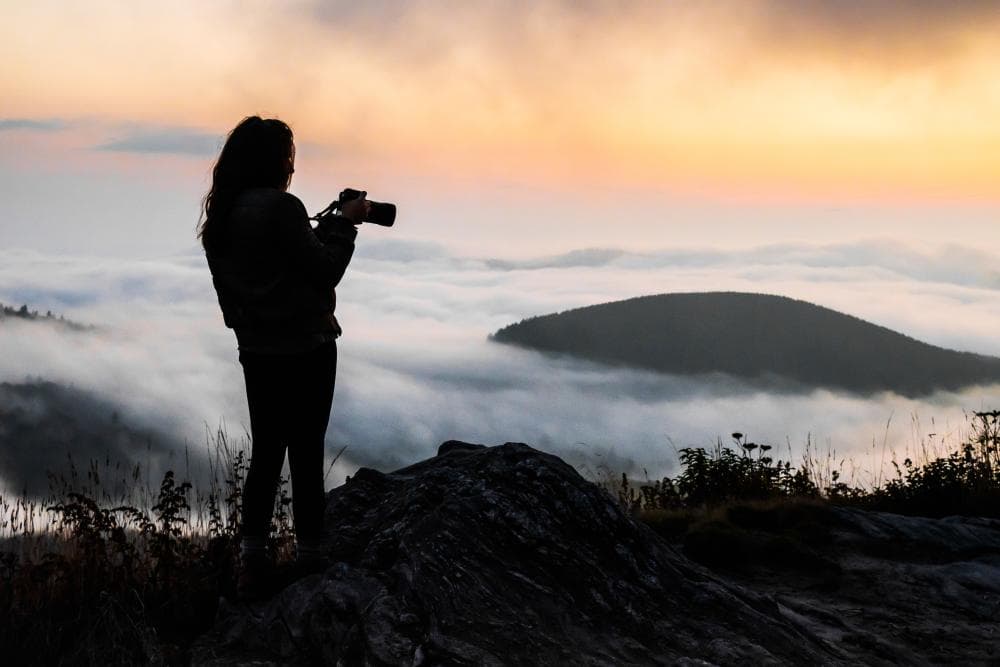 A photographer at sunset along the Blue Ridge Parkway near Asheville, NC A photographer at sunset along the Blue Ridge Parkway near Asheville, NC