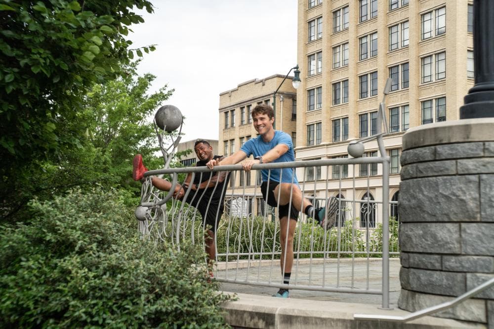 Two runners stretching in downtown Asheville Two runners stretching in downtown Asheville