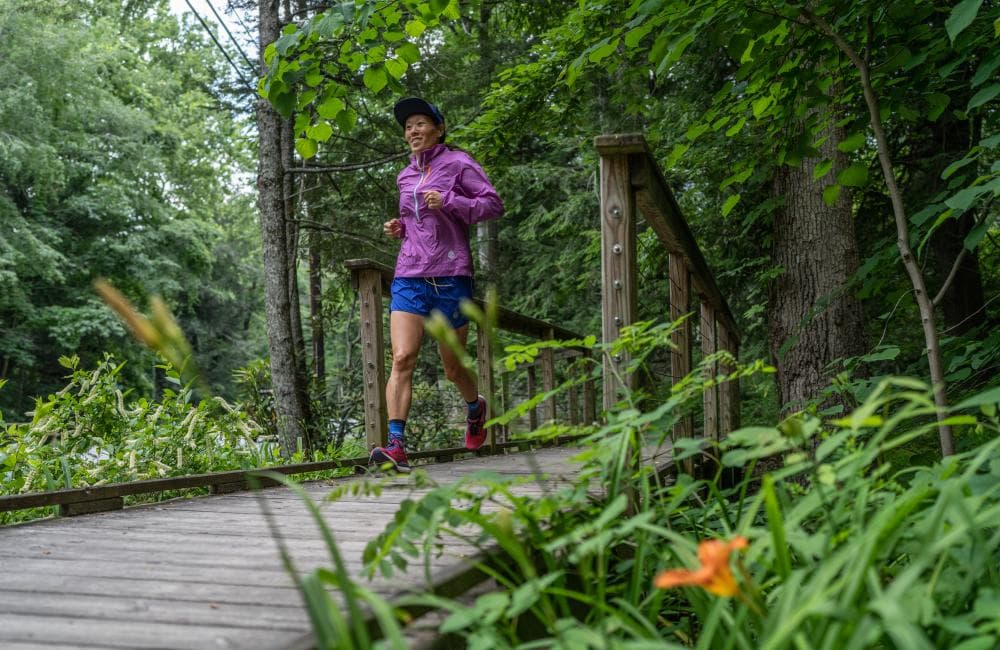 Woman running across bridge in Montreat Woman running across bridge in Montreat