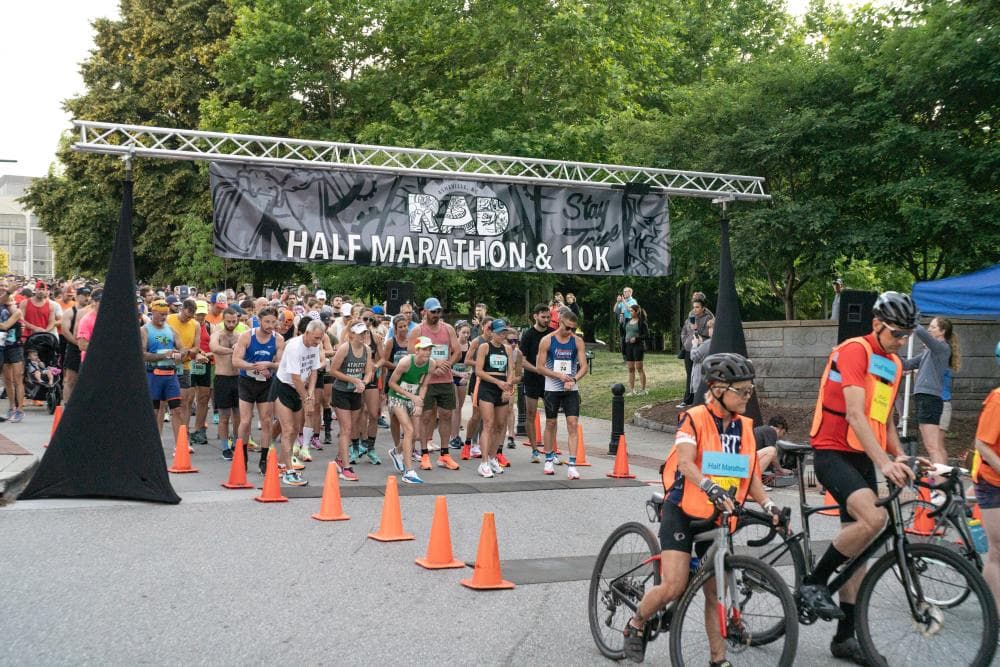 Runners starting at the starting line at the River Arts District Marathon and 10K Runners starting at the starting line at the River Arts District Marathon and 10K