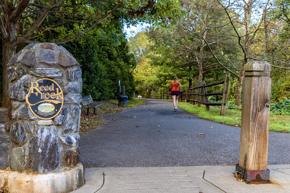 Woman jogging on path of Reed Creek Greenway Woman jogging on path of Reed Creek Greenway