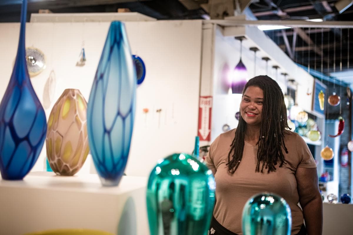 Woman admiring glass artwork Woman admiring glass artwork