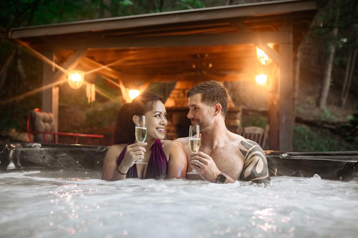 Couple sitting in a hot tub drinking Champagne. Couple sitting in a hot tub drinking Champagne.