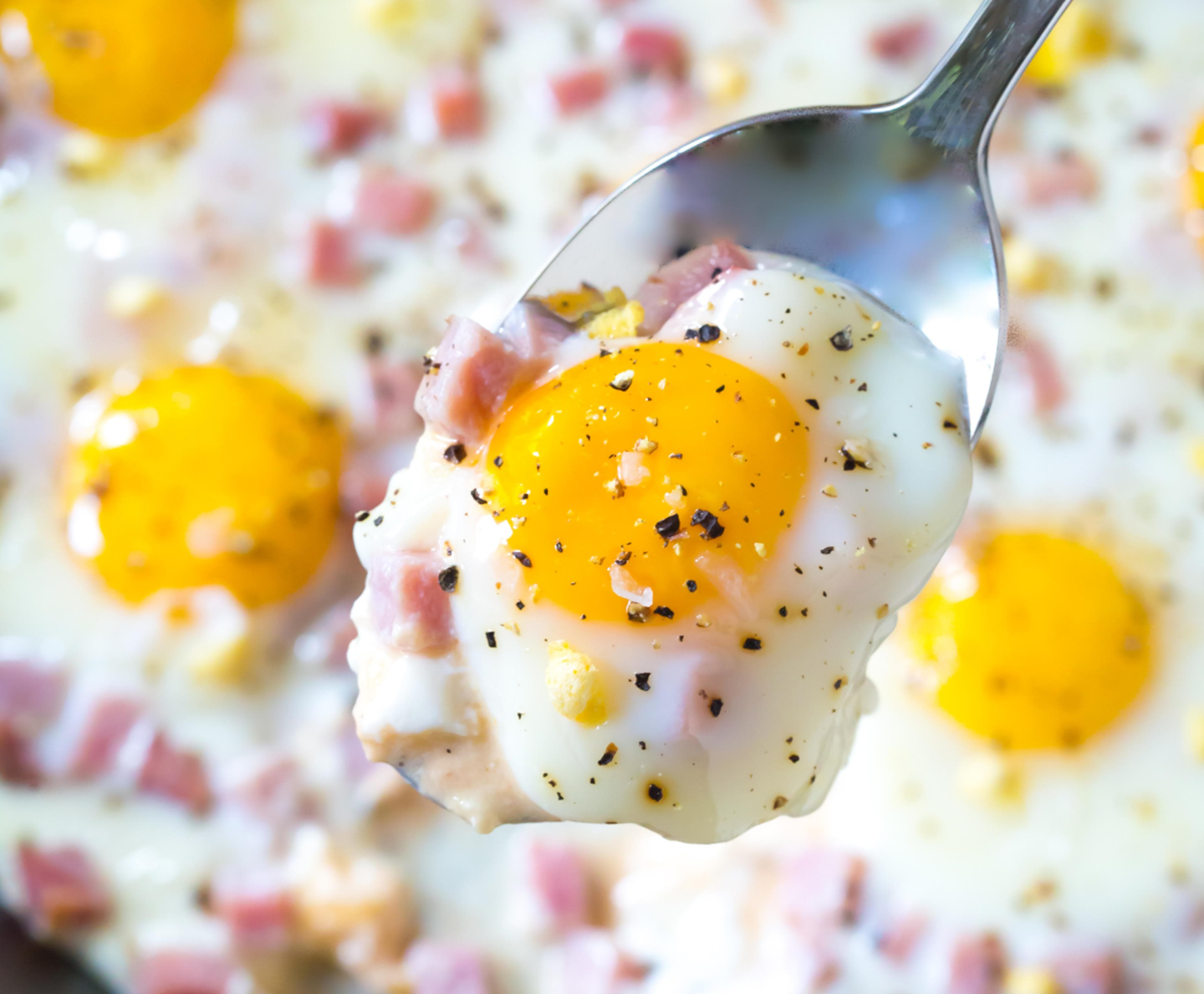 baked eggs with bright-yellow yolks sprinkled with ham baked eggs with bright-yellow yolks sprinkled with ham