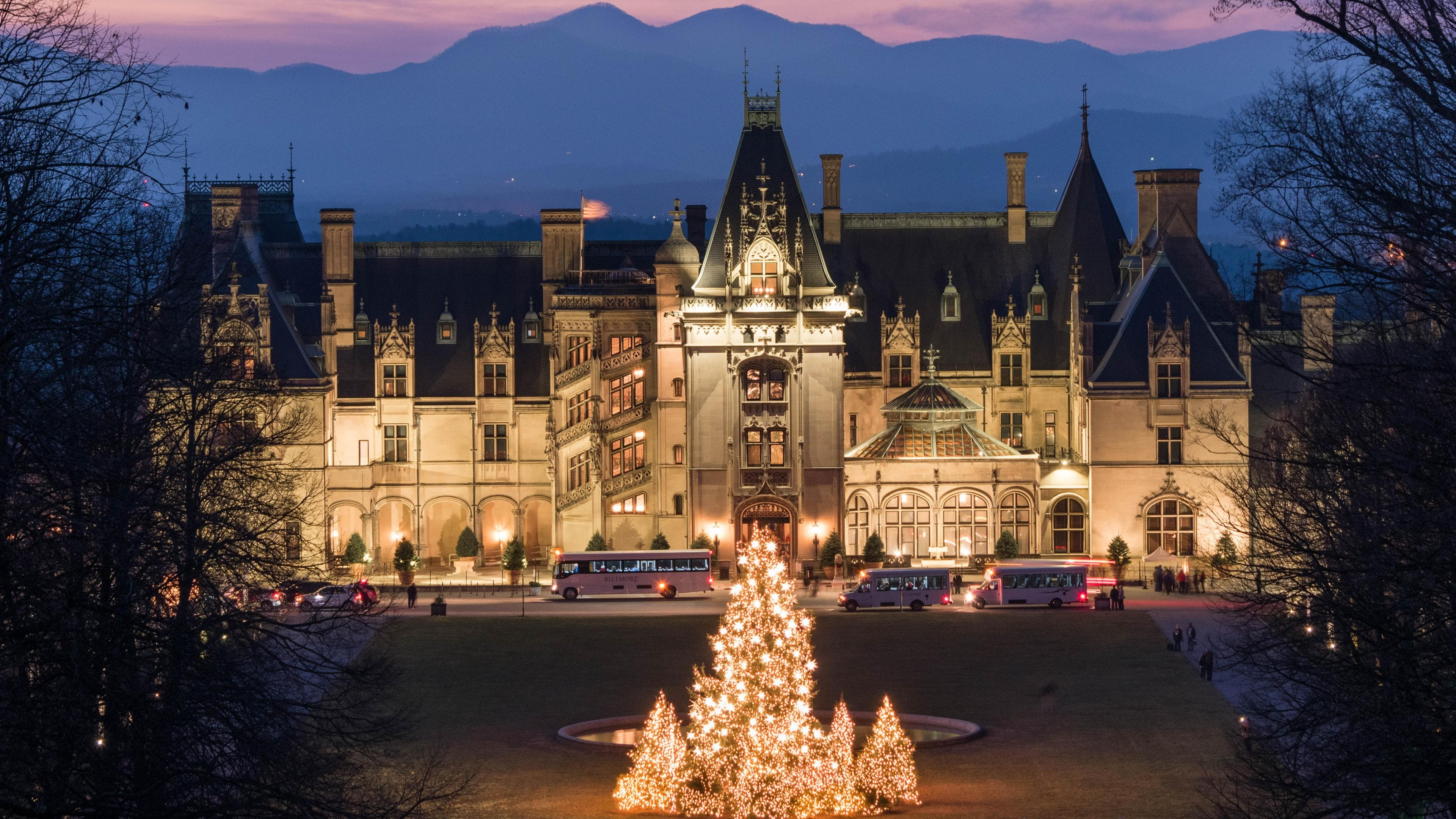 the glowing exterior of the Biltmore at Christmastime in Asheville the glowing exterior of the Biltmore at Christmastime in Asheville