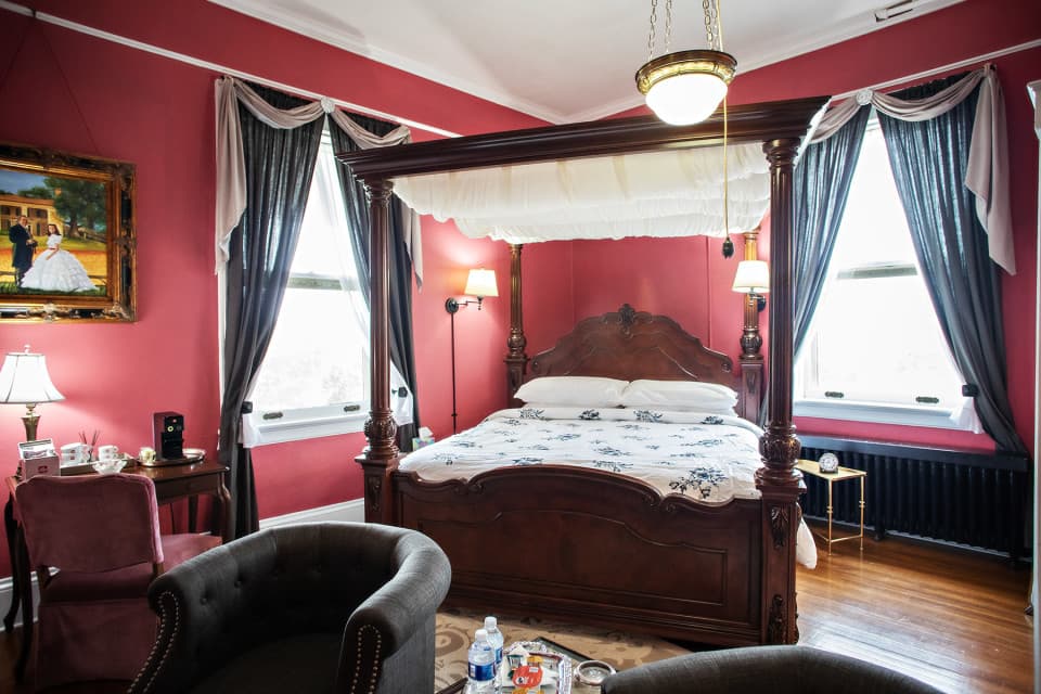 Located on the south west corner of the second floor this King guest room with it’s dramatic canopy bed is directly off the upper porch access and features westward sunset views of the mountains and comfortable fireplace seating. Located on the south west corner of the second floor this King guest room with it’s dramatic canopy bed is directly off the upper porch access and features westward sunset views of the mountains and comfortable fireplace seating.