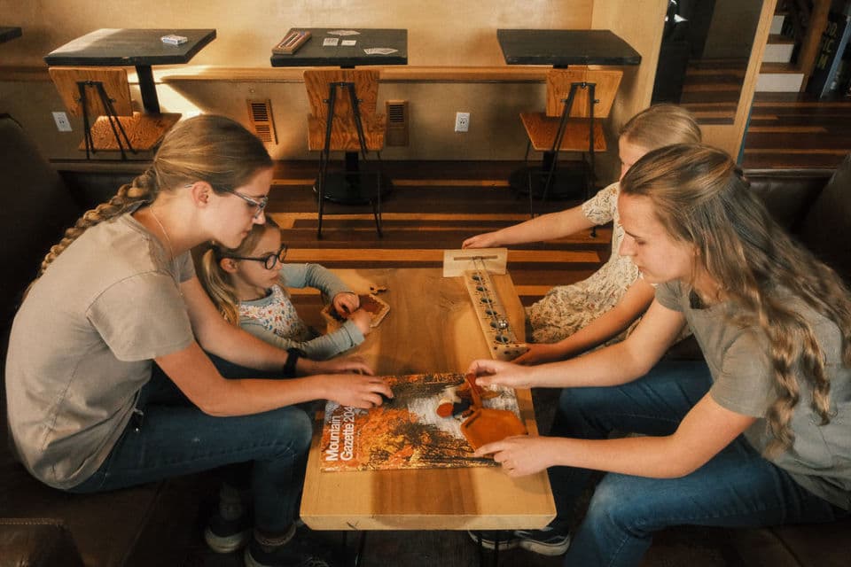 A family playing games in the River Lodge. A family playing games in the River Lodge.