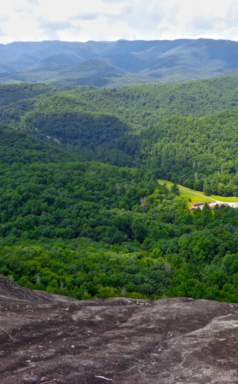 John Rock Trail An aerial view of lush forest and rolling hills from John Rock Trail in Asheville