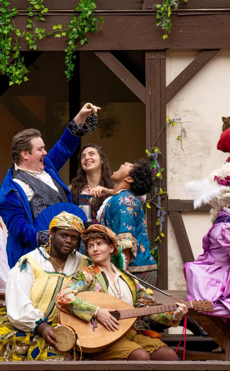 Experience Outdoor Shakespeare Performances in Asheville, NC people in Sheakspearian costumes pose on a stage